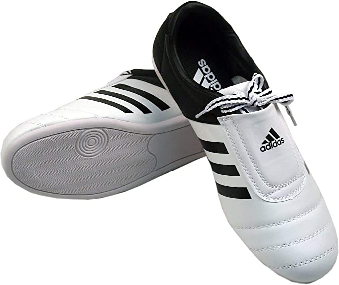 Taekwondo shoes made by Adidas designed for training, featuring durable materials for long-lasting use. Lightweight and supportive with a comfortable fit. Made with high-quality synthetic leather, ensuring breathability and grip. Ideal for martial arts practitioners.