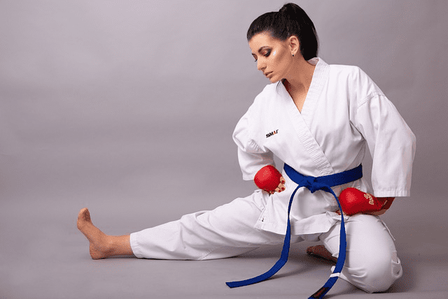 A martial arts student with blue belt, doing warm up