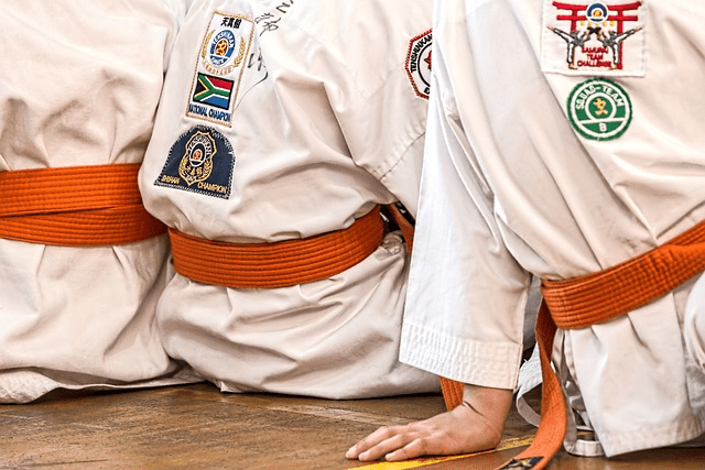 Martial arts students with orange belts