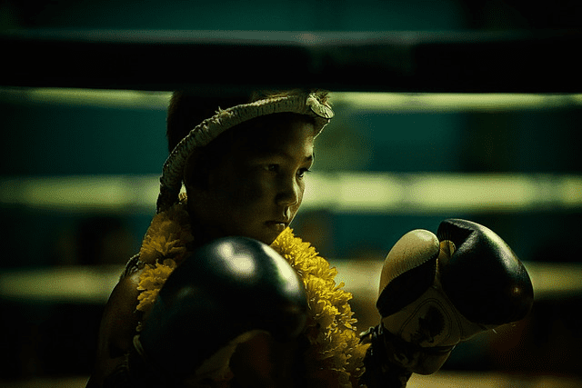 A kid reading themself for a Muay Thai match