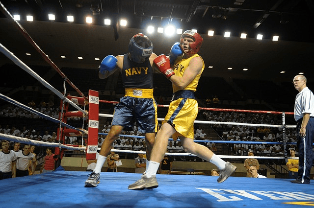 A boxing ring with two boxer in the middle of a match